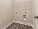 Efficient laundry room with modern flooring, essential hookups, and shelving for organized storage at 395 S Crow Creek Dr. # 1704, Calabash, NC 28467