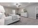 Light-filled main bedroom featuring a ceiling fan, ensuite bathroom, and ample storage space at 395 S Crow Creek Dr. # 1704, Calabash, NC 28467