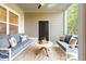 Serene screened-in porch with comfortable lounge seating and a relaxing atmosphere amidst lush greenery at 395 S Crow Creek Dr. # 1704, Calabash, NC 28467