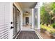 Inviting screened-in porch featuring covered seating, decorative rug, and open views to a lush backyard at 395 S Crow Creek Dr. # 1704, Calabash, NC 28467
