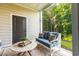 Relaxing screened-in porch with comfortable seating, accent pillows, and a serene view of the lush greenery at 395 S Crow Creek Dr. # 1704, Calabash, NC 28467