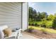 Cozy screened porch with outdoor chair, small table with decorative items, and a serene backyard view at 395 S Crow Creek Dr. # 1704, Calabash, NC 28467