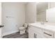 Modern bathroom featuring white cabinets and countertops, undermount sink, and plank flooring at 395 S Crow Creek Dr. # 1709, Calabash, NC 28467
