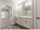 Modern bathroom showcasing a double vanity with a large mirror and a doorway to the bedroom at 395 S Crow Creek Dr. # 1709, Calabash, NC 28467