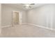 Bedroom with soft carpeting, ceiling fan, and open door to the bathroom at 395 S Crow Creek Dr. # 1709, Calabash, NC 28467
