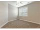 Carpeted bedroom with large window, neutral walls, and modern trim at 395 S Crow Creek Dr. # 1709, Calabash, NC 28467
