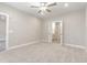 Spacious bedroom with soft carpeting, ceiling fan, and open double doors at 395 S Crow Creek Dr. # 1709, Calabash, NC 28467