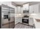 Bright kitchen showcasing white cabinets and stainless steel appliances at 395 S Crow Creek Dr. # 1709, Calabash, NC 28467