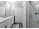 Modern bathroom featuring double vanity, quartz counters, and tiled shower with glass door at 395 S Crow Creek Dr. # 1710, Calabash, NC 28467