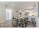 Dining area with a round table and chairs adjacent to the bright, modern kitchen at 395 S Crow Creek Dr. # 1710, Calabash, NC 28467