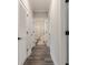 Hallway with wood floors leads to a bathroom featuring a shower-tub combo at 395 S Crow Creek Dr. # 1710, Calabash, NC 28467