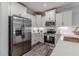 Beautiful kitchen with stainless steel appliances, white cabinets, and a spacious layout at 395 S Crow Creek Dr. # 1710, Calabash, NC 28467