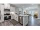 Modern kitchen with white cabinets, stainless steel appliances, and an island with seating at 395 S Crow Creek Dr. # 1710, Calabash, NC 28467