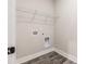 Empty laundry room ready for washer and dryer hookups with gray wood-look floors at 395 S Crow Creek Dr. # 1710, Calabash, NC 28467