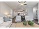 Bright living room with a comfortable sofa and chairs next to an open concept kitchen at 395 S Crow Creek Dr. # 1710, Calabash, NC 28467