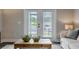 Comfortable living room featuring french doors, neutral colors, and a stylish coffee table at 395 S Crow Creek Dr. # 1710, Calabash, NC 28467