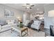Bright living room with a comfortable sofa and chairs next to an open concept kitchen at 395 S Crow Creek Dr. # 1710, Calabash, NC 28467