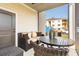 Covered patio with an outdoor seating area and partial view of the apartment complex at 395 S Crow Creek Dr. # 1710, Calabash, NC 28467
