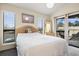 Relaxing bedroom with an outdoor view, balcony access, and warm natural light filtering through window blinds at 408 Tree Top Ct. # A, Myrtle Beach, SC 29588