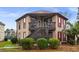Exterior shot of a home with a raised balcony and landscaped greenery at 408 Tree Top Ct. # A, Myrtle Beach, SC 29588