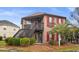 Charming exterior with lush bushes and stairs to the second floor balcony at 408 Tree Top Ct. # A, Myrtle Beach, SC 29588