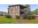 Two-story home featuring stairs to the balcony and well-maintained landscaping at 408 Tree Top Ct. # A, Myrtle Beach, SC 29588
