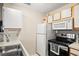 Well-equipped kitchen boasting essential appliances, efficient layout, and practical cabinet storage for organization at 408 Tree Top Ct. # A, Myrtle Beach, SC 29588