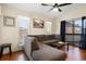 Cozy living room with a large sectional sofa, hardwood floors, and a view from large windows at 408 Tree Top Ct. # A, Myrtle Beach, SC 29588