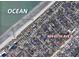 Aerial view showing property's proximity to the ocean and surrounding neighborhood at 409 65Th Ave. N, Myrtle Beach, SC 29572