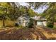 Backyard with a brick house, shrubs, trees, privacy fence, and a concrete patio with slider at 409 65Th Ave. N, Myrtle Beach, SC 29572