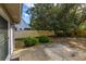 Secluded backyard patio features mature trees and privacy wall offering peaceful outdoor living at 409 65Th Ave. N, Myrtle Beach, SC 29572