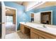 Bathroom featuring dual sinks and an ensuite bathroom with plenty of natural light at 409 65Th Ave. N, Myrtle Beach, SC 29572