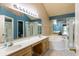 Bright bathroom with double sinks, shower, soaking tub, and neutral tile flooring at 409 65Th Ave. N, Myrtle Beach, SC 29572