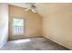 Simple bedroom with beige walls, a window with white blinds, and plush carpet at 409 65Th Ave. N, Myrtle Beach, SC 29572