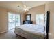 Bright bedroom featuring sliding glass doors, a ceiling fan, and neutral-toned walls at 409 65Th Ave. N, Myrtle Beach, SC 29572