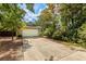 Home with a wide driveway leading to a two-car garage surrounded by mature trees at 409 65Th Ave. N, Myrtle Beach, SC 29572