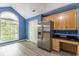 Bright kitchen with stainless steel refrigerator, wooden cabinets and a beautiful arched window at 409 65Th Ave. N, Myrtle Beach, SC 29572
