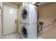 Efficient laundry area showcasing stacked washer and dryer, and tile flooring at 409 65Th Ave. N, Myrtle Beach, SC 29572