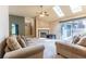 Bright living room featuring a fireplace, ceiling fan, skylights, and sliding glass doors to the outside at 409 65Th Ave. N, Myrtle Beach, SC 29572