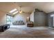 Living room featuring a ceiling fan, skylights, sliding glass doors, and neutral-toned carpeting at 409 65Th Ave. N, Myrtle Beach, SC 29572