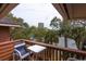 A cozy balcony features seating and scenic waterfront views surrounded by lush greenery at 410 Melrose Pl. # 308, Myrtle Beach, SC 29572