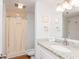 Cozy bathroom featuring a shower, granite vanity, and framed coastal art at 410 Melrose Pl. # 308, Myrtle Beach, SC 29572