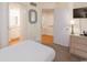 Comfortable bedroom with light colored walls with an ensuite bathroom at 410 Melrose Pl. # 308, Myrtle Beach, SC 29572