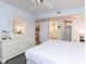 A bedroom with a large bed, ensuite, and closet offers comfort and functionality at 410 Melrose Pl. # 308, Myrtle Beach, SC 29572