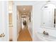 Bright hallway with wood floors, white walls, and decorative coastal accents at 410 Melrose Pl. # 308, Myrtle Beach, SC 29572