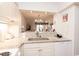 Open kitchen pass-through offering views to dining area and beyond at 410 Melrose Pl. # 308, Myrtle Beach, SC 29572