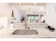 Kitchen pass through with granite counters and sightlines to dining area at 410 Melrose Pl. # 308, Myrtle Beach, SC 29572