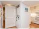 Laundry closet featuring stacked washer and dryer, adjacent to the kitchen at 410 Melrose Pl. # 308, Myrtle Beach, SC 29572