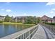 Picturesque wooden bridge over a serene pond, nestled within a lush residential community at 410 Melrose Pl. # 308, Myrtle Beach, SC 29572