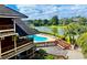 Stunning aerial view of a community pool and serene lake surrounded by lush landscape at 410 Melrose Pl. # 308, Myrtle Beach, SC 29572